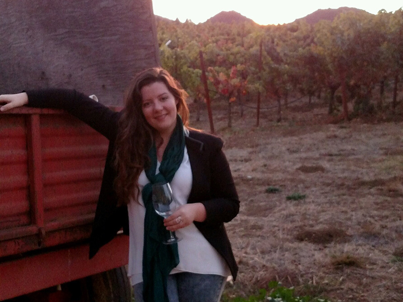 Allison Ritter Mixologist Allison holding a wine glass at a winery